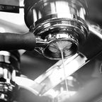 Close-up of espresso from Espresso & Milk Preparation 09/25 2-5pm extracting from a portafilter into a cup.