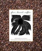 Four Barrel Coffee package with black artwork on a bed of coffee beans