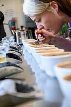 Person tasting coffee at a coffee shop
