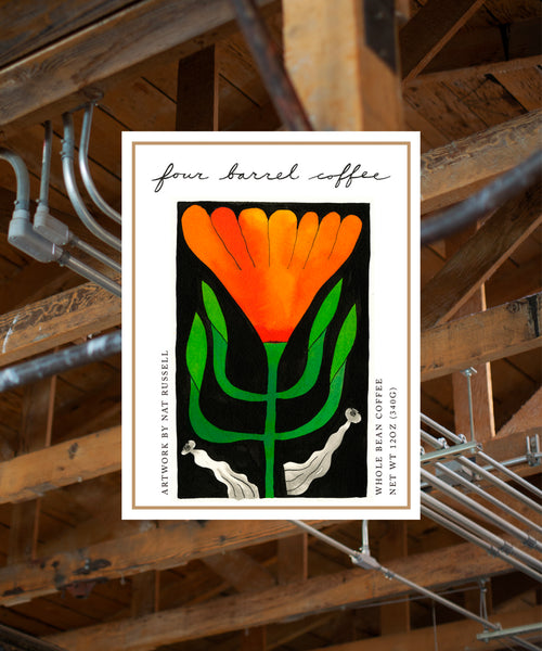 Four Barrel Coffee label with orange flower design on a wooden background