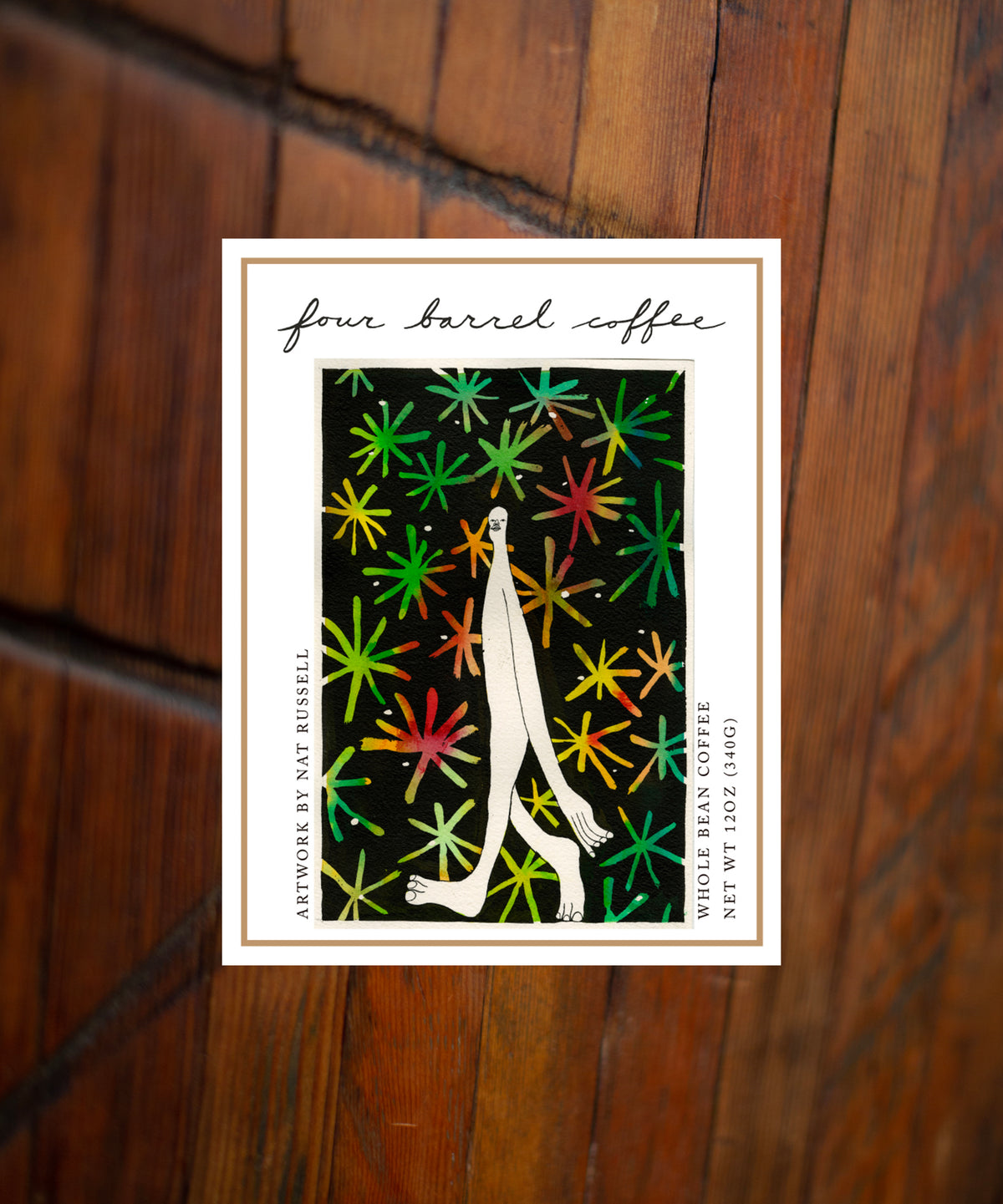 Four Barrel Coffee packaging with colorful design on a wooden surface