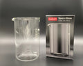 A French Press Glass Replacement beaker next to its original product box.