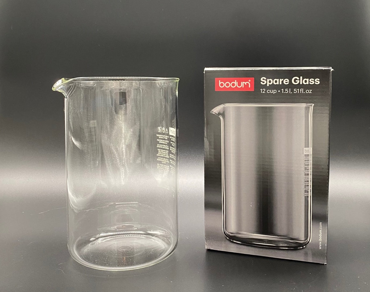A French Press Glass Replacement beaker next to its original product box.