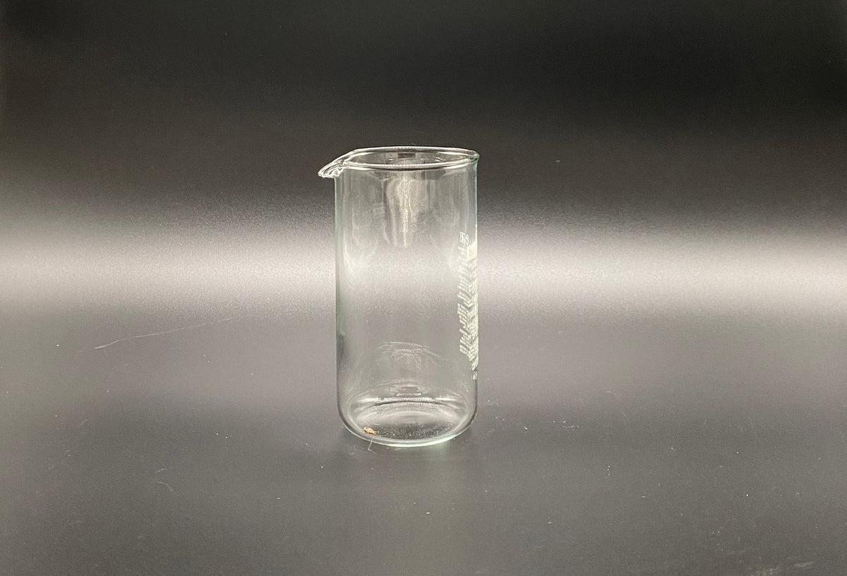 A cylindrical French Press Glass Replacement beaker with a small pouring spout.
