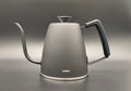 A black Hario 'Smart G' Drip Kettle on a gray background.
