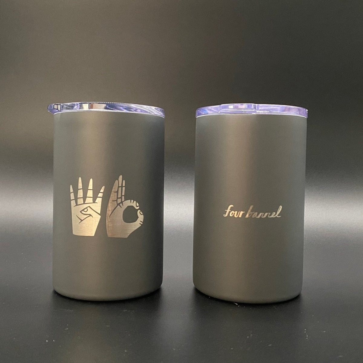 Two matte gray 4B HAND TUMBLERs with clear lids; one features a hand sign graphic and the other features the text four barrel.
