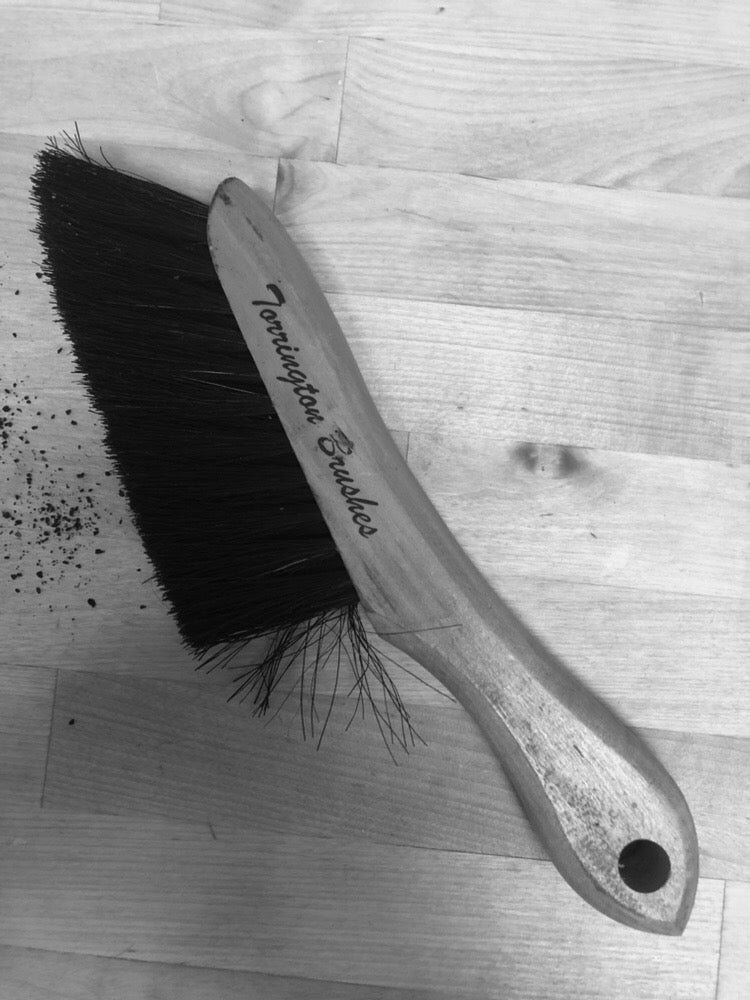 Torrington wood counter brush with black bristles and a hole in the handle.